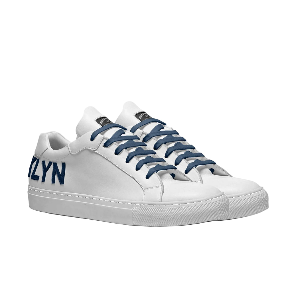 Shop the Contemporary Low Top Sneaker in White & Navy. Italian craftsmanship, bold branding, padded comfort, and a durable rubber sole.

White and navy luxury low-top sneaker

Italian designer tennis sneaker

Unisex contemporary casual sneaker

Luxury low top sneakers, Italian designer sneakers, white navy sneakers, unisex luxury footwear, tennis-inspired sneakers, everyday designer shoes