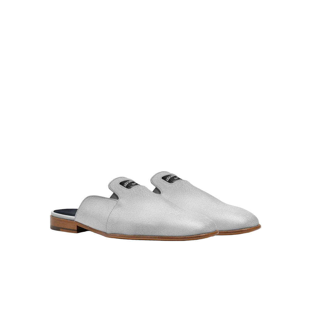 Luxury Italian silver mule slipper with squared toe and embossed logo

Designer summer mule slipper crafted from Italian materials by Alaila Carroll Style

Elegant silver mule with loafer-inspired topline and low-profile silhouette