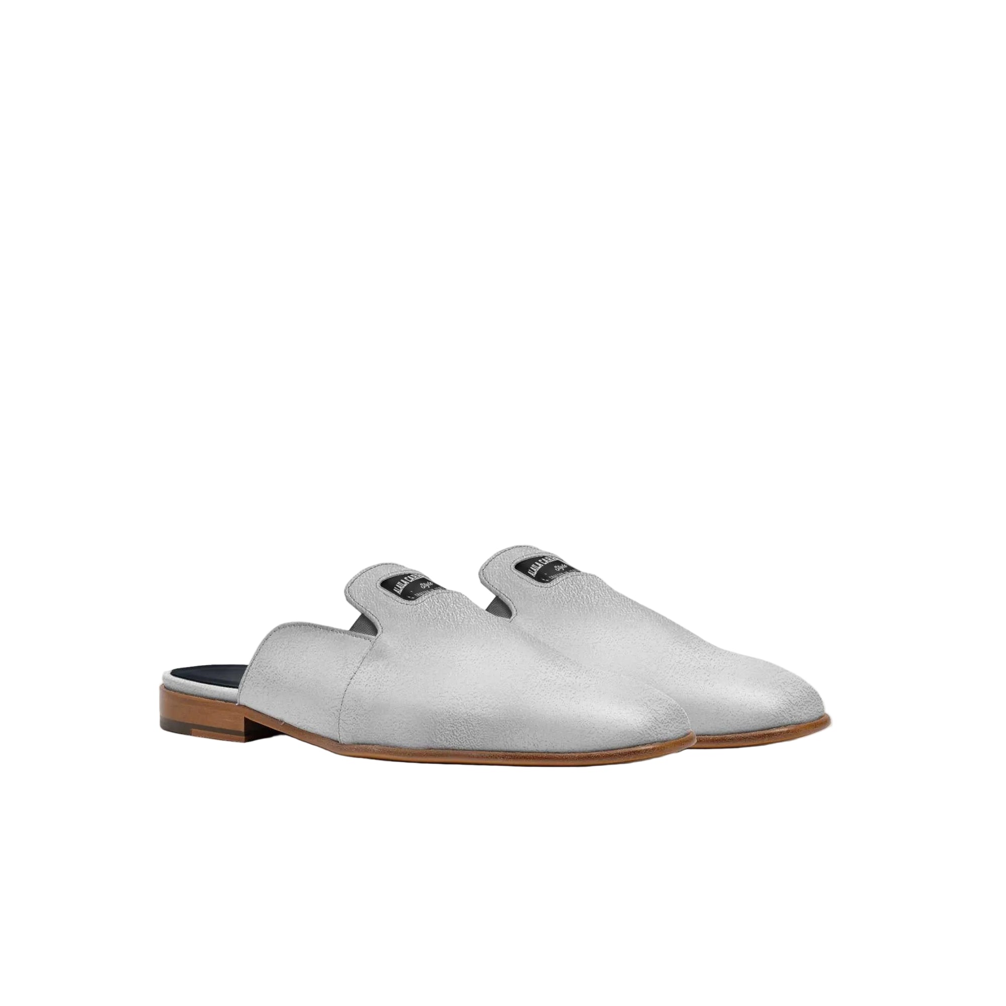 Luxury Italian silver mule slipper with squared toe and embossed logo

Designer summer mule slipper crafted from Italian materials by Alaila Carroll Style

Elegant silver mule with loafer-inspired topline and low-profile silhouette
