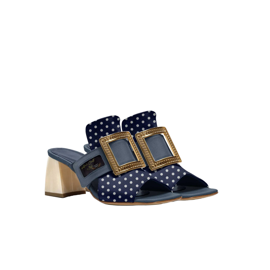 Luxury slide sandal handcrafted in Italy

Blue, gold & white polka-dot design

Fine cutout upper with wide strap

Oversized gold-tone buckle

2-inch block heel for stability

Lightly padded insole for comfort

Signature Alaila Carroll Style logo detail

Ideal for casual wear, summer fashion, and travel